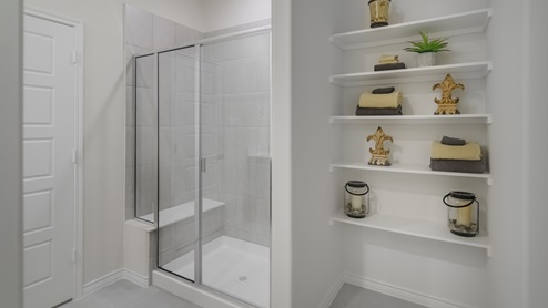 Large primary bathroom with storage shelves and standup shower