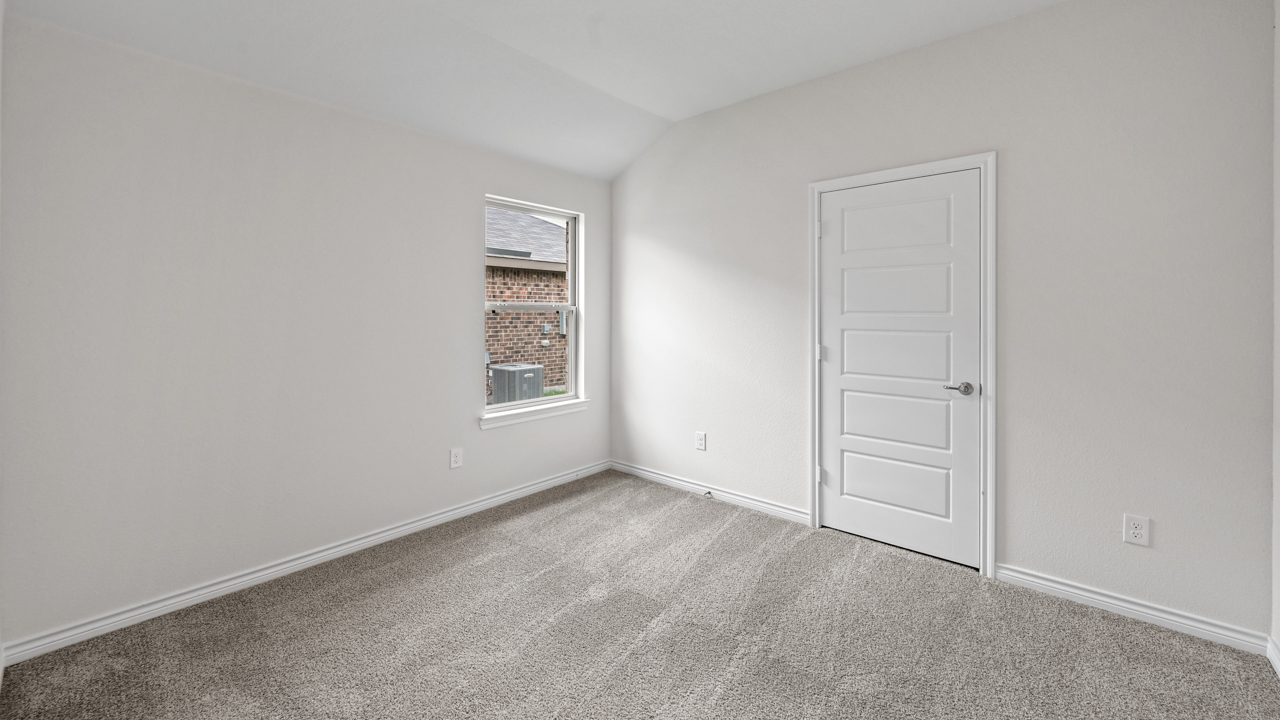 open bedroom with gray carpet and windows