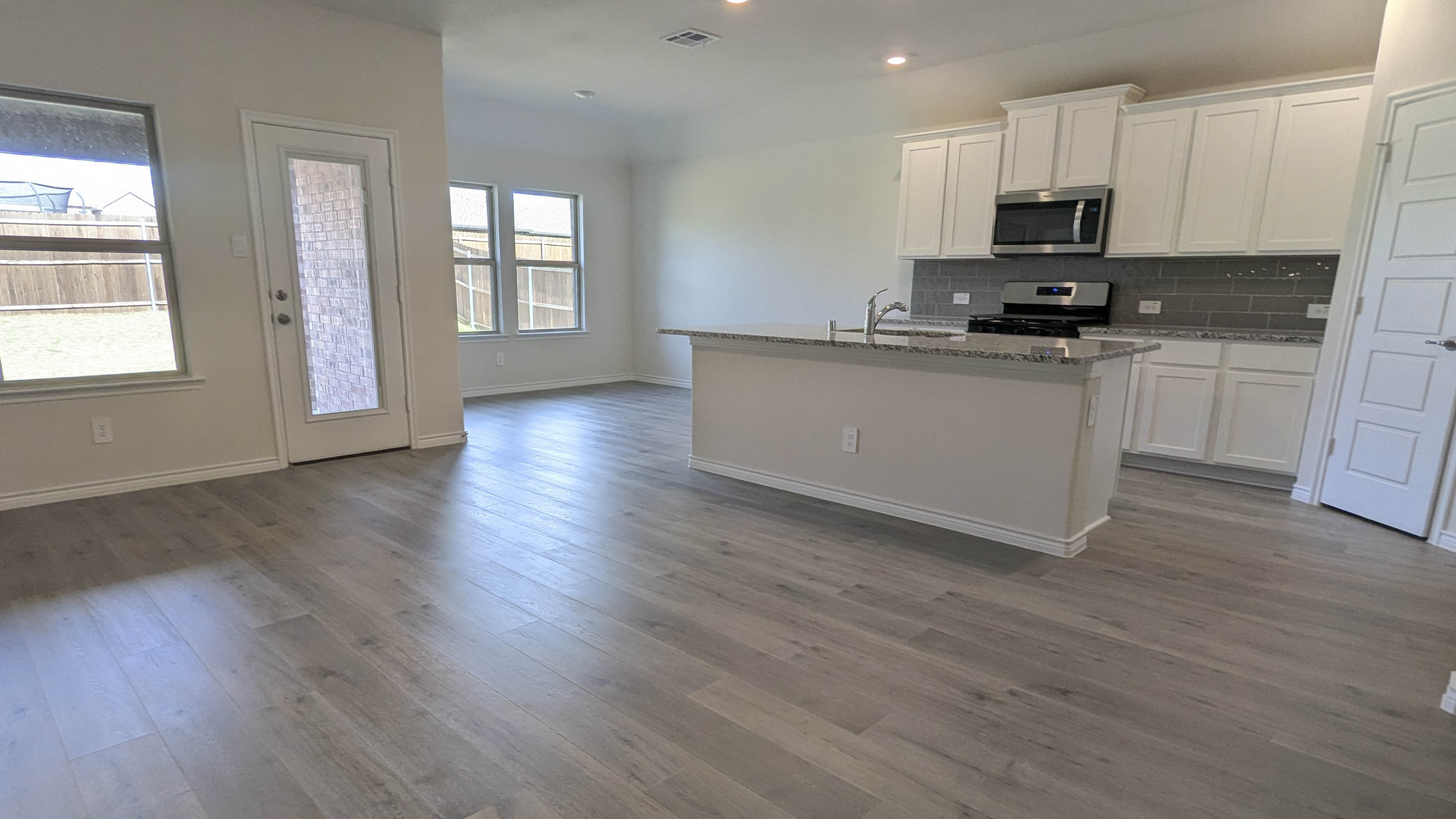 open concept living area with hardwood floors and natural light