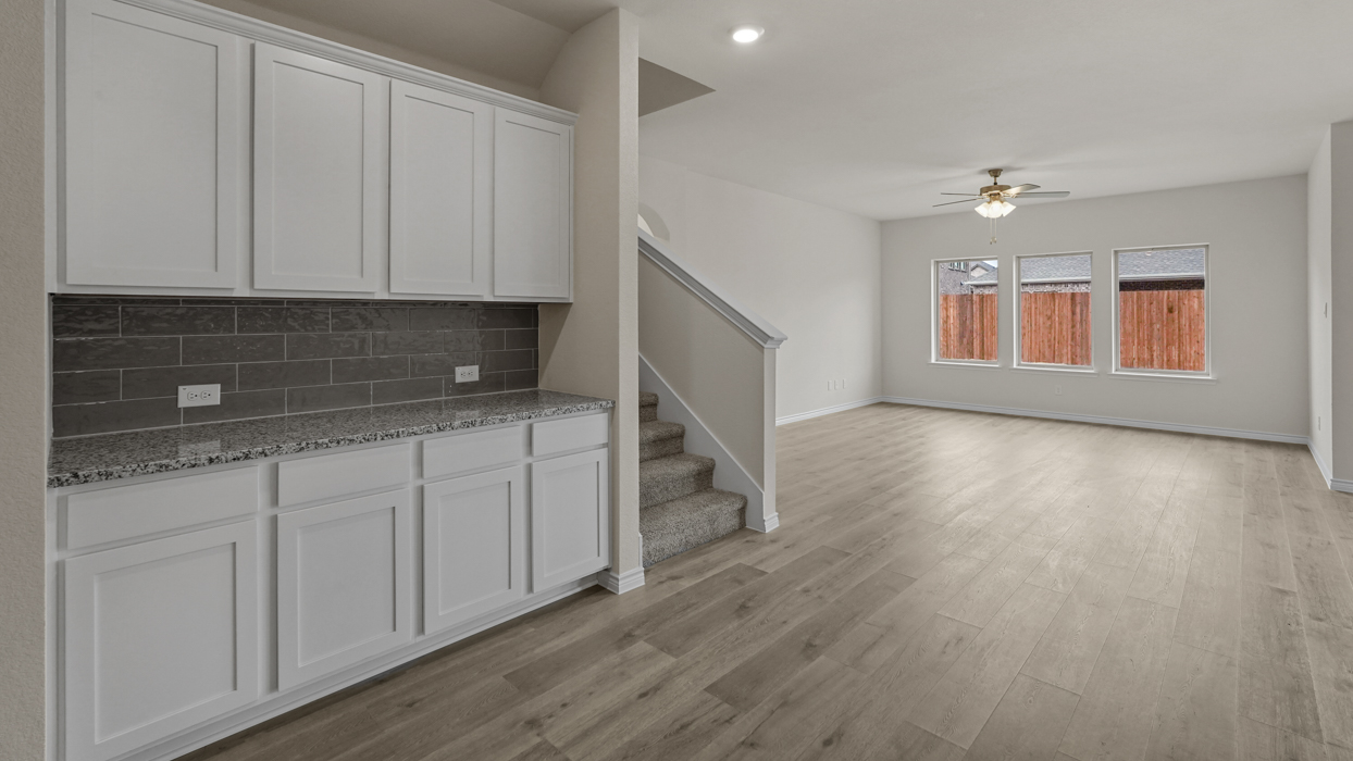 butlers kitchen with white cabinets and views into living room