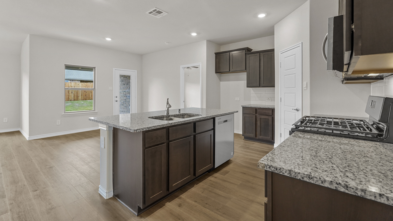 view of kitchen island overlooking breakfast nook and back door