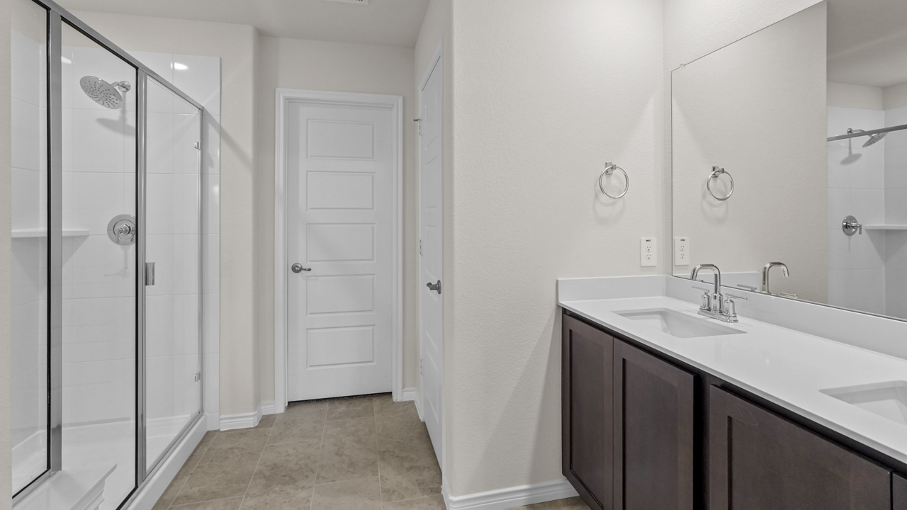 primary bathroom with elongated vanity and walk in shower