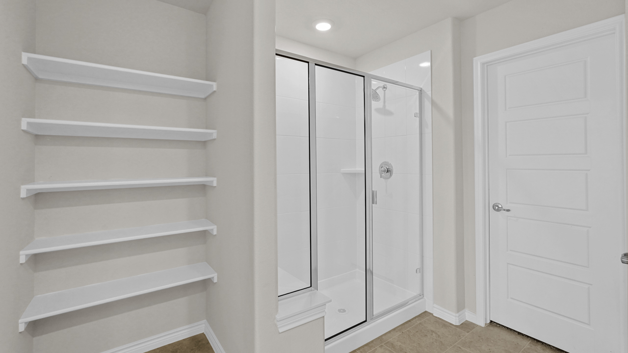 primary bathroom storage shelves and large walkin shower