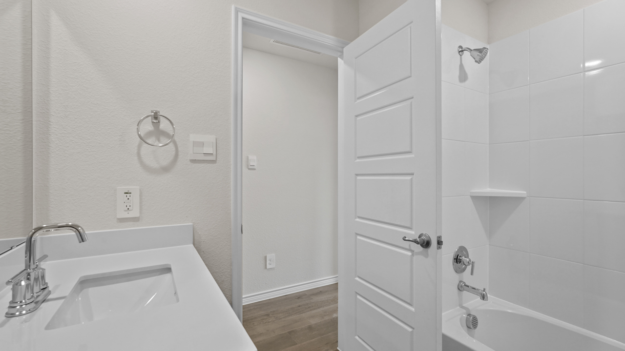 secondary bathroom with vanity and garden tub