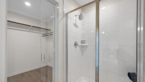 The primary bathroom with stand up shower and large walk-in closet