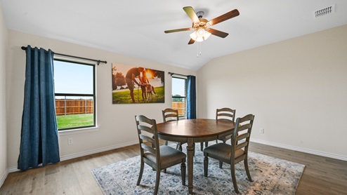 A large primary bedroom with a temporary workspace table