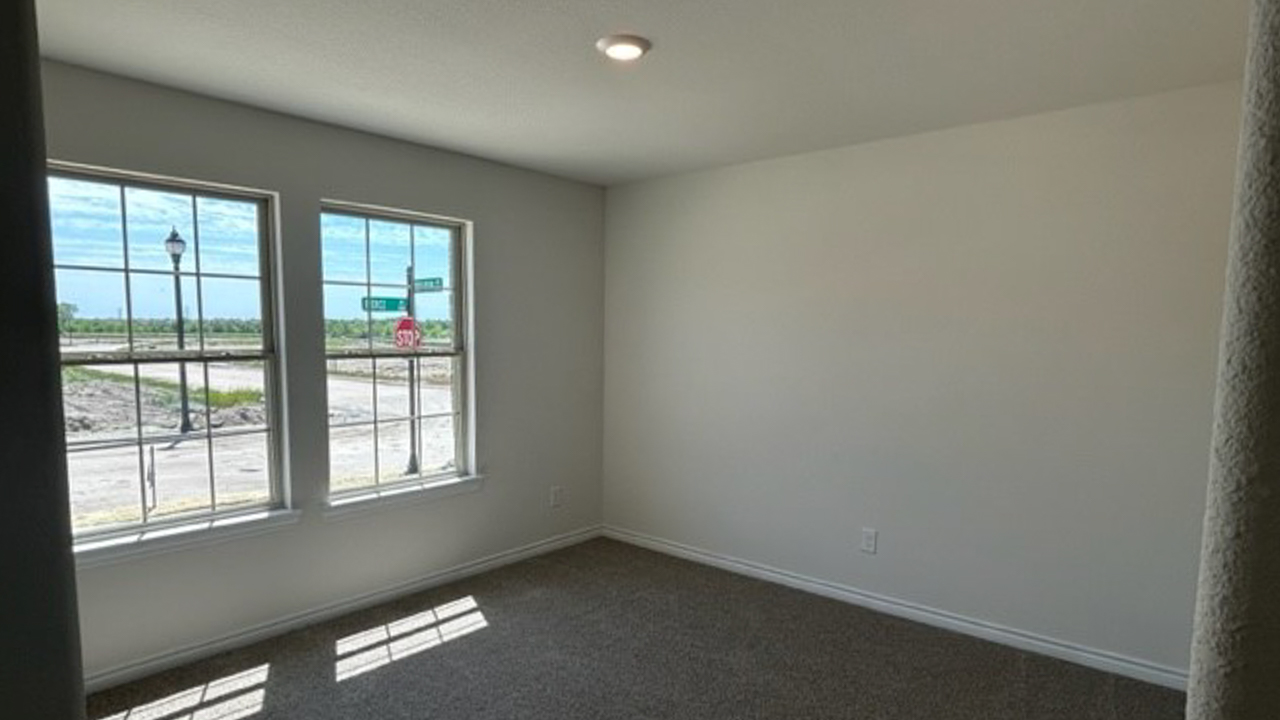 secondary bedroom with large windows providing natural light