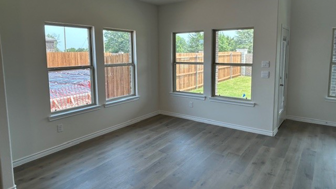 dining area with hardwood floors and large windows providing natural light