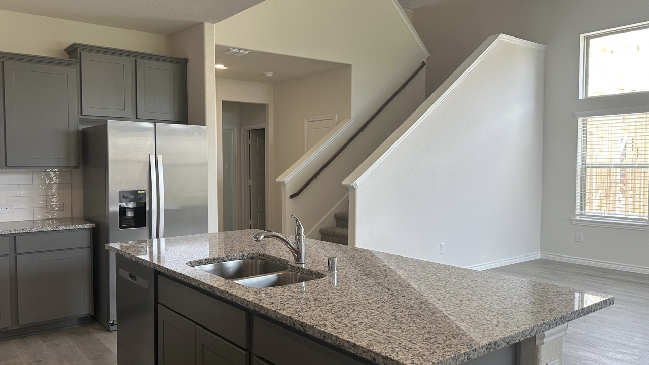 kitchen island area with granite counters and living area