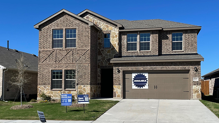 Two story home with brick siding and 2 car garage