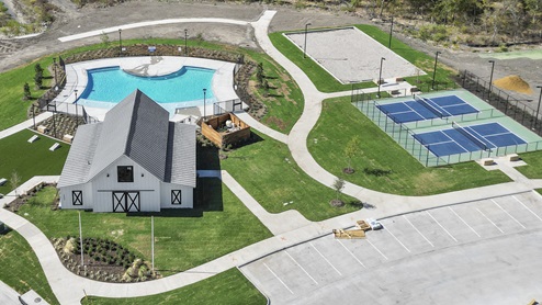 an aerial photo of the amenity center next to the pool and pickleball court