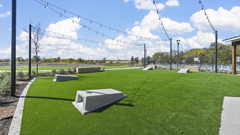 green space with built in cornhole boards