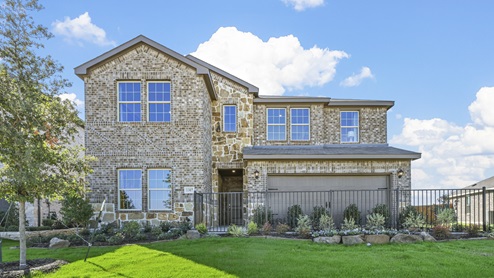 two story model home with brick and stone