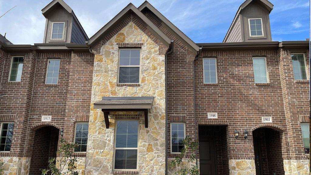 Two story townhome with stone exterior