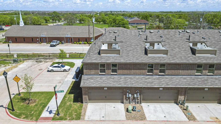 exterior of the back of the townhome with garage entry