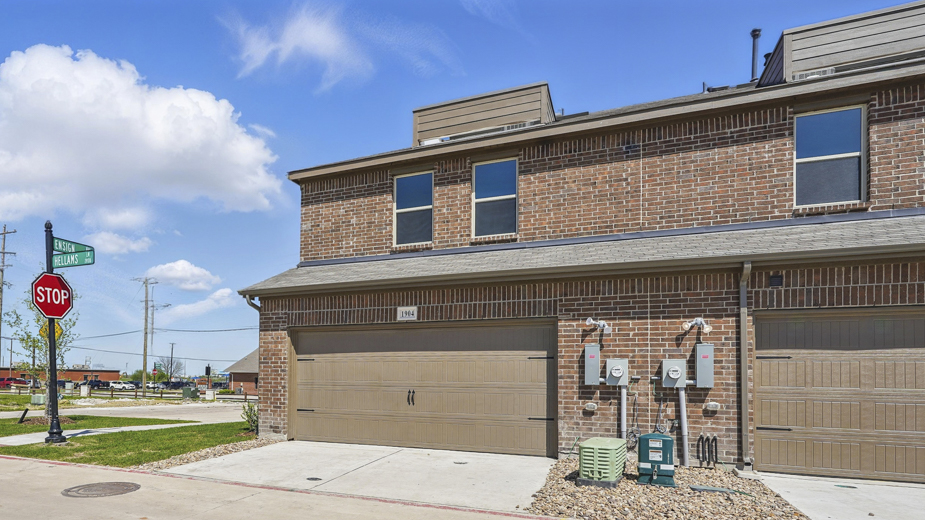 exterior of the back of the townhome with garage entry