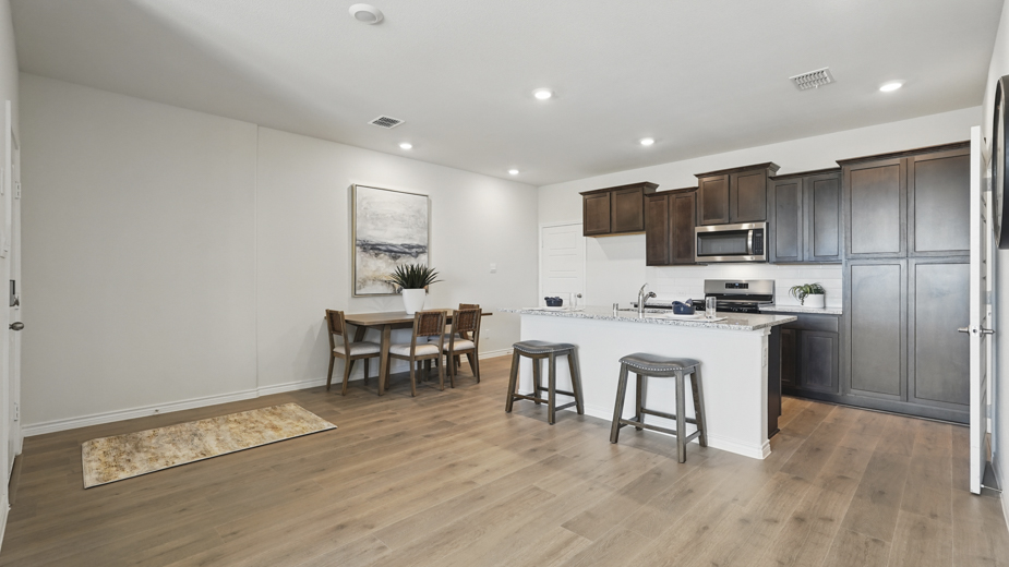 open concept living area with hardwood floors and views of the kitchen
