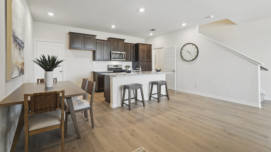 open concept living area with hardwood floors and views of the kitchen