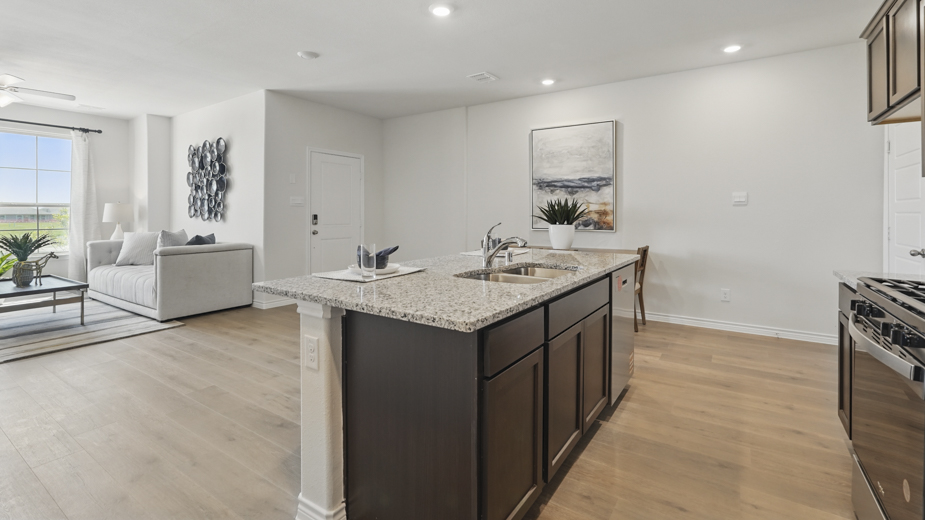 kitchen area with hardwood floors dark cabinets and light colored counters