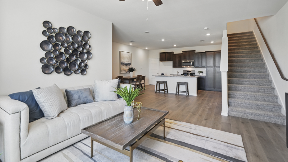 open concept living area with hardwood floors and natural light coming from large windows
