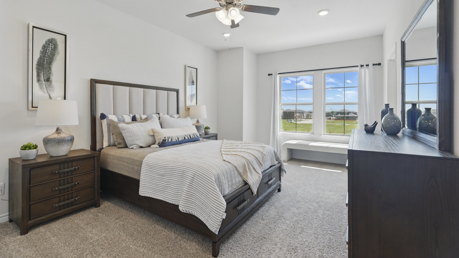 primary bedroom with large windows providing natural light to the entire room
