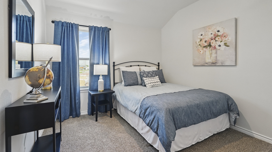 secondary bedroom with hardwood floors and natural coming from the large window