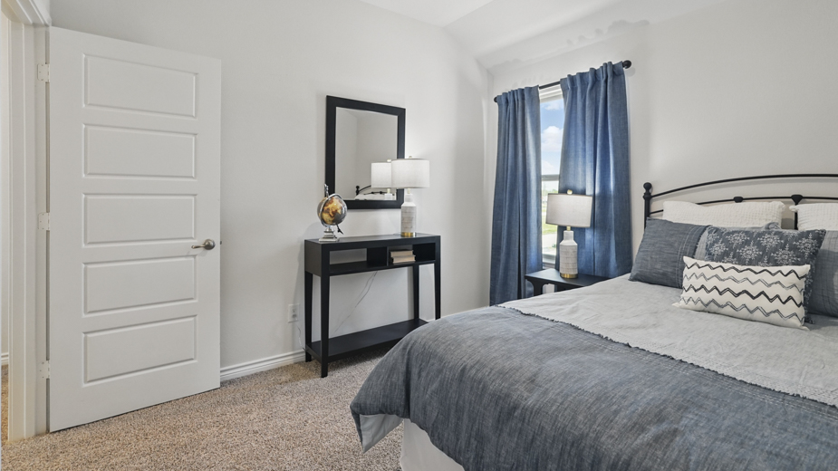 secondary bedroom with hardwood floors and natural coming from the large window