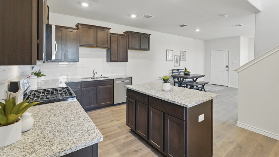 kitchen area with hardwood floors dark cabinets and white counters