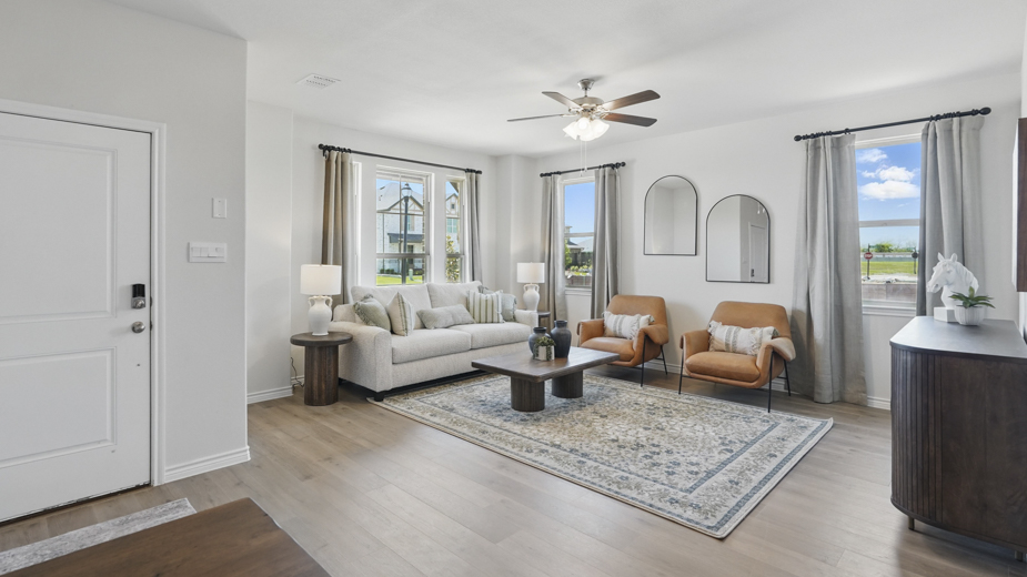 open concept living area with hardwood floors and large windows providing natural lighting