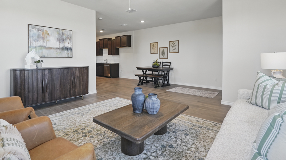 open concept living area with hardwood floors and large windows providing natural lighting