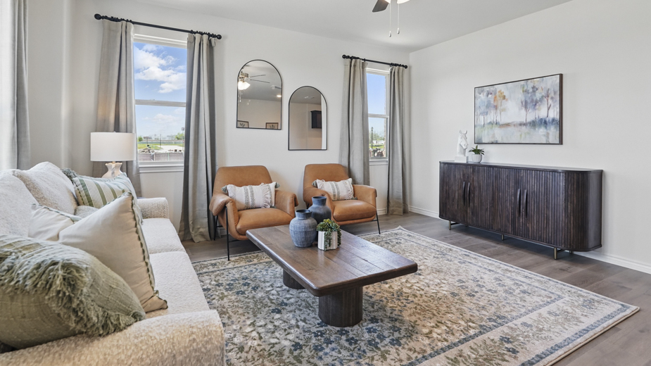 open concept living area with hardwood floors and large windows providing natural lighting