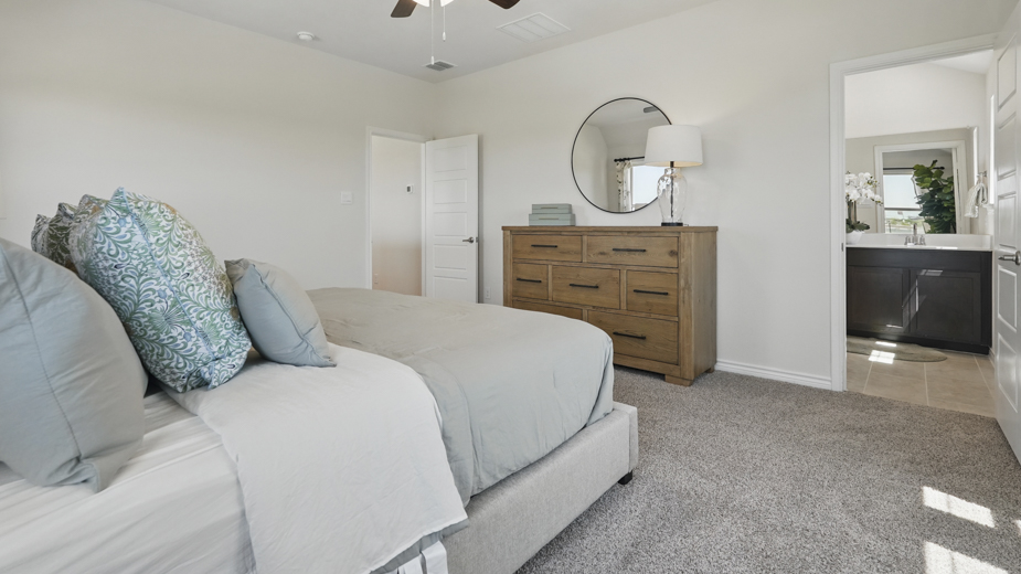 primary bedroom with carpet and large windows providing natural light