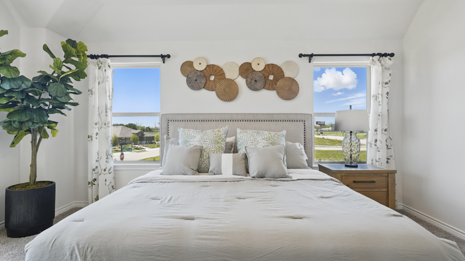 primary bedroom with carpet and large windows providing natural light