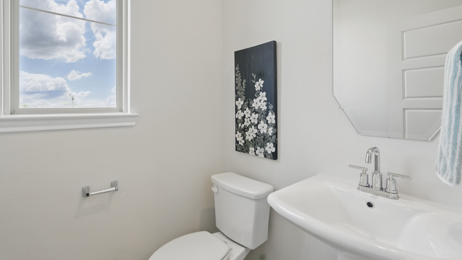 secondary bathroom with white counters and dark cabinets