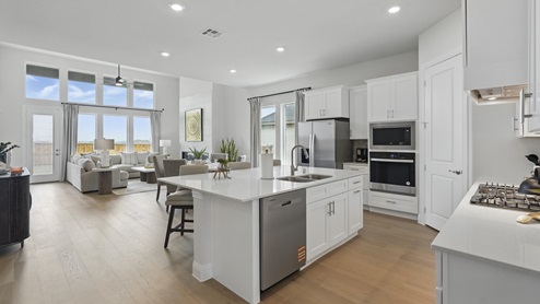 Interior of kitchen with large island looking into living room