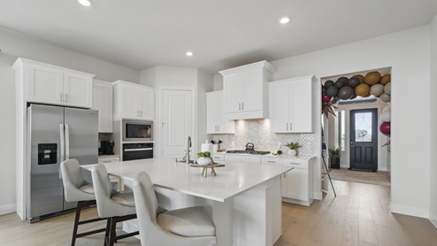 Interior kitchen with white cabinets and large central island