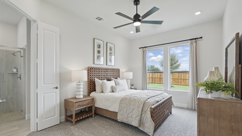 Interior bedroom with large window and private bathroom