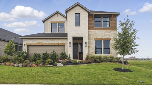 Exterior of two story brick home with two car garage model home