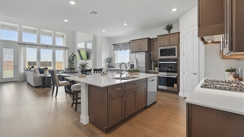 Interior of kitchen with large island looking into living room