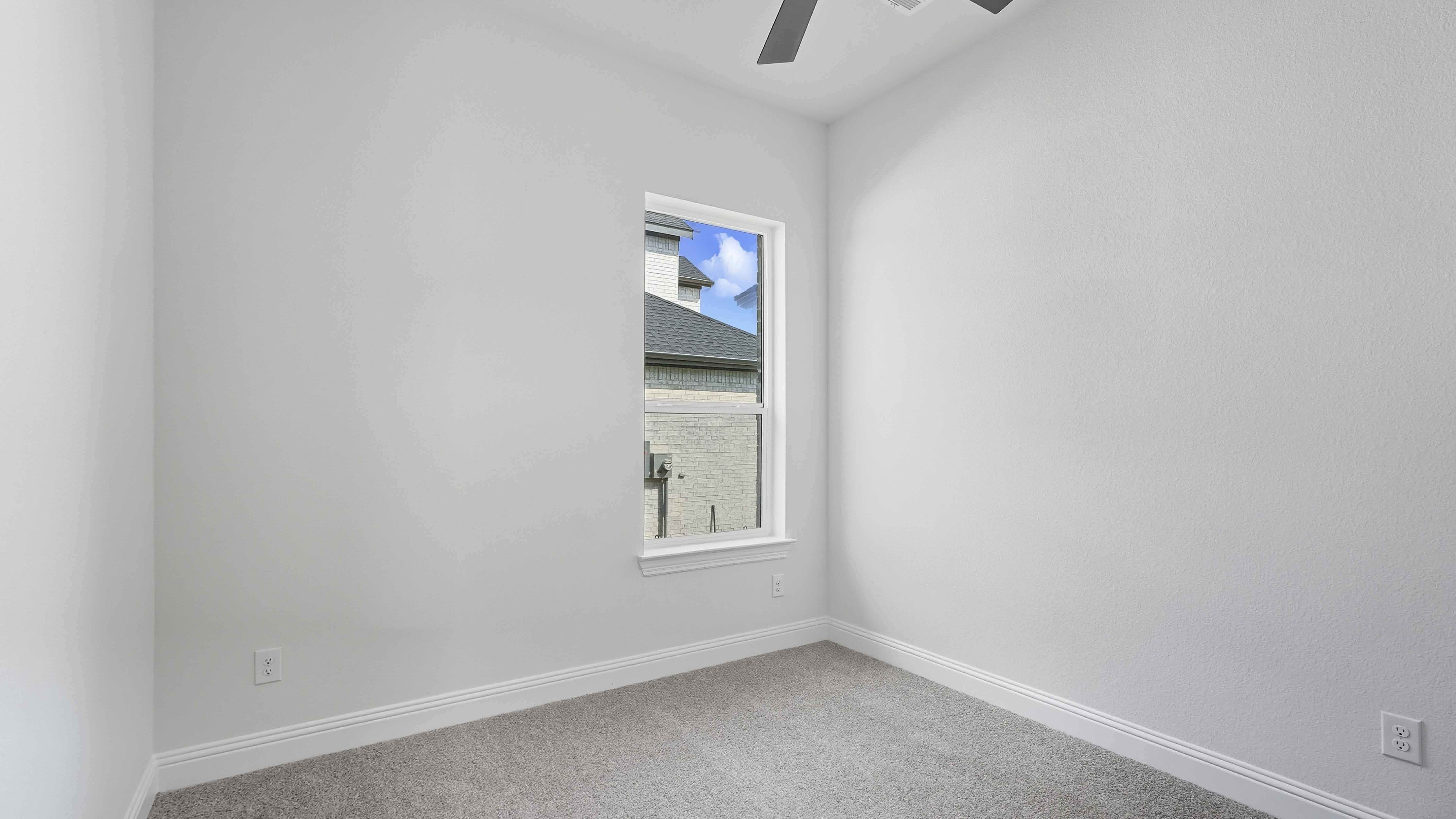 secondary bedroom with large window providing natural light