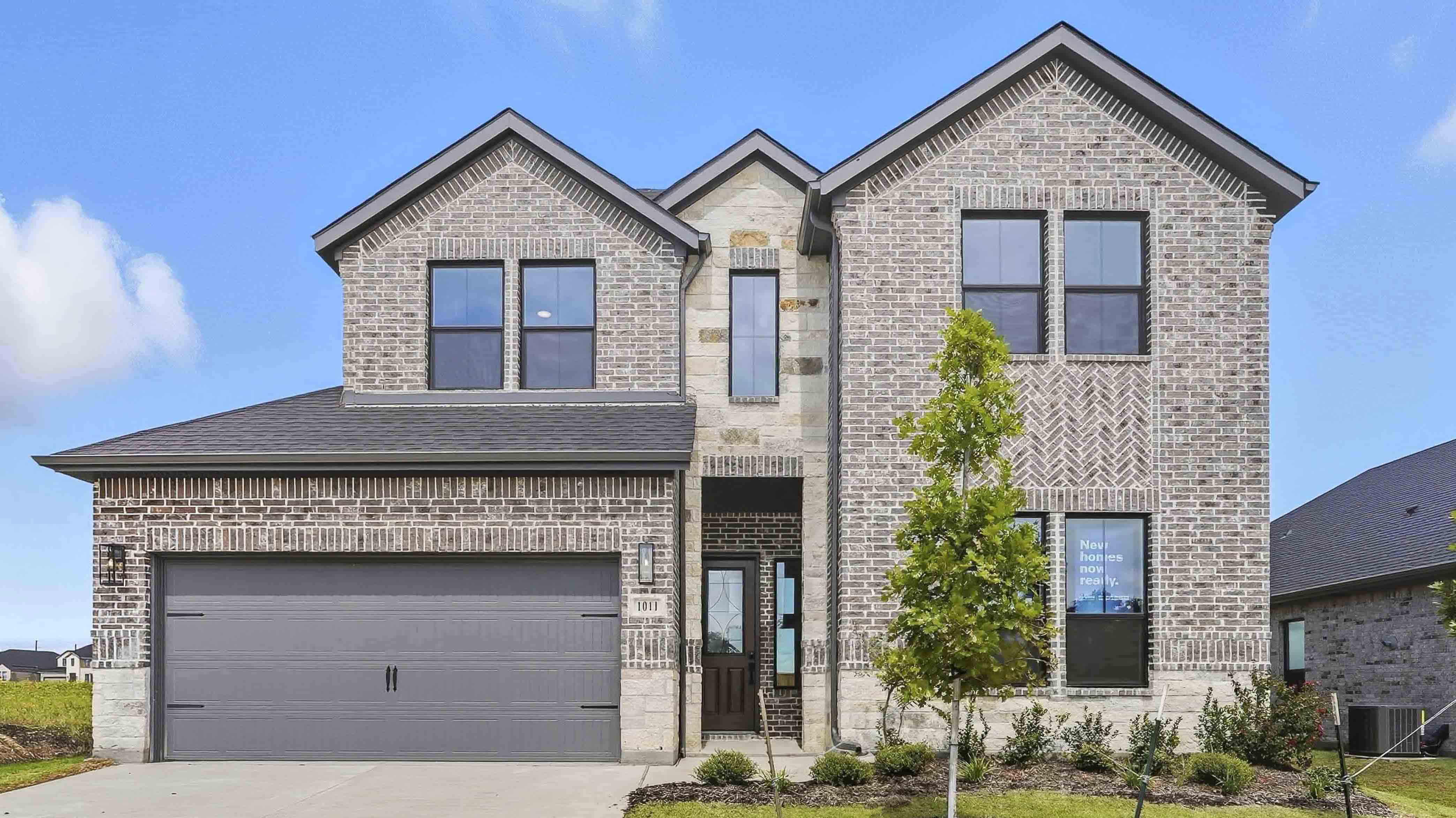 exterior of two story home with brick and stone