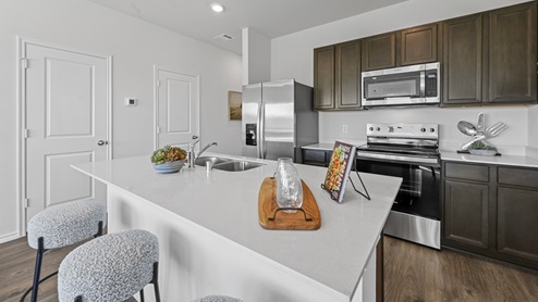 Kitchen with brown cabinets and large white countertop island