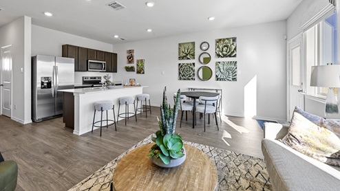 V19 Plan Interior of kitchen and living room area with kitchen island and windows