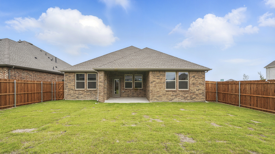 Rear exterior of home with covered back patio.