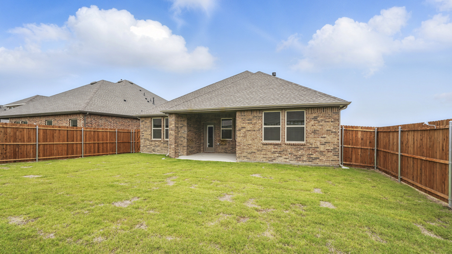 Rear exterior of home with covered back patio.
