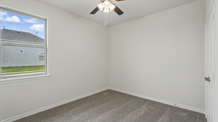 Bedroom with a single window and carpeted floors.