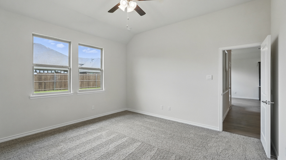 Bedroom with a single window and carpeted floors.