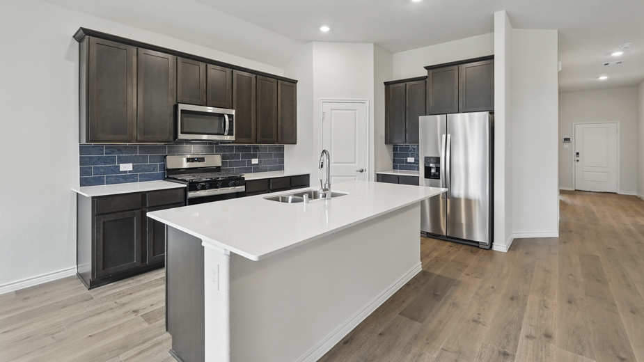 Kitchen with blue tile backsplash.