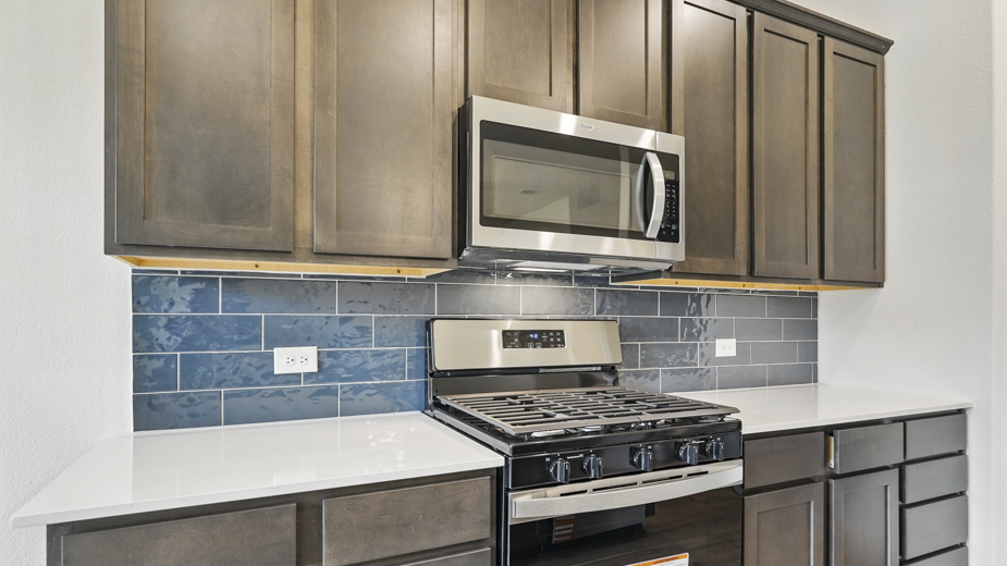Kitchen with blue tile backsplash.