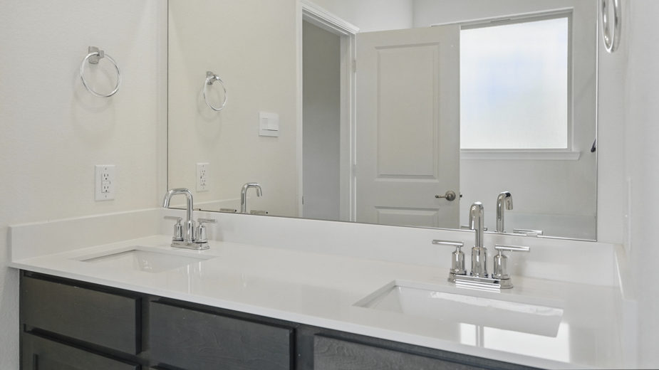 Primary bathroom with double vanity sinks.